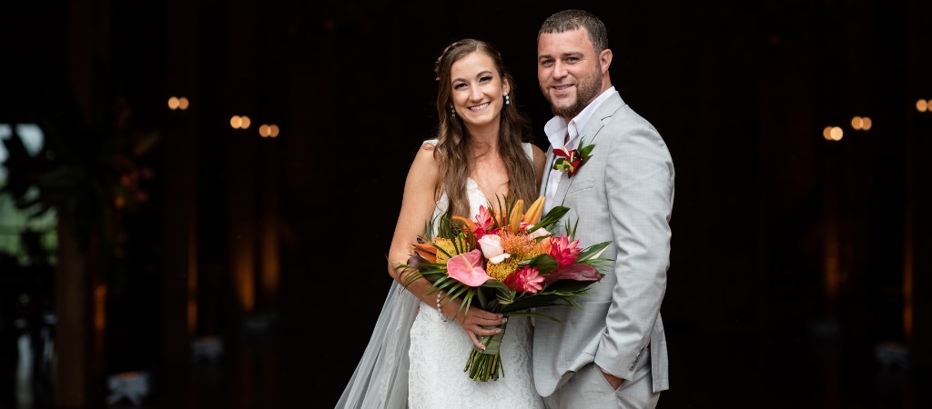 A bride and groom posing and looking at the camera